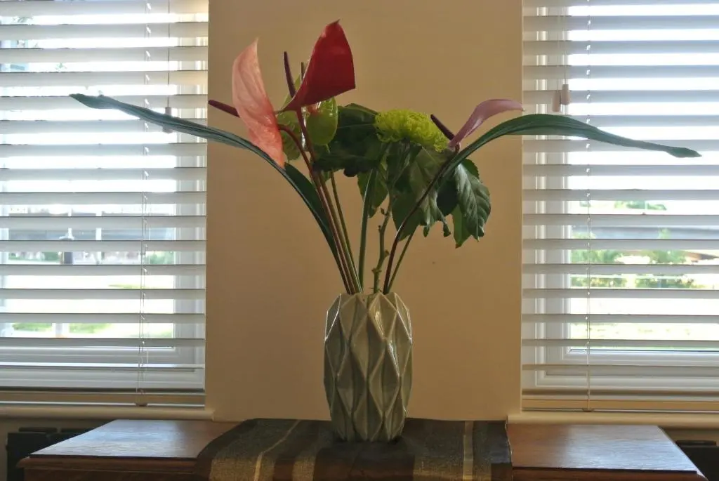 a vase with flowers in it on a table at The Little House by the Ness in Inverness