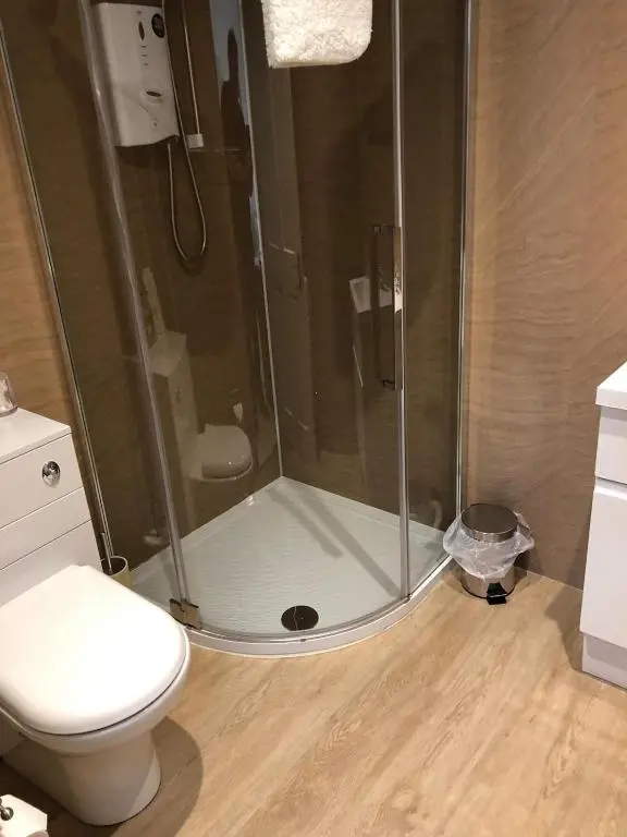 a bathroom with a shower and a toilet at Drumdale Bed and Breakfast in Inverness
