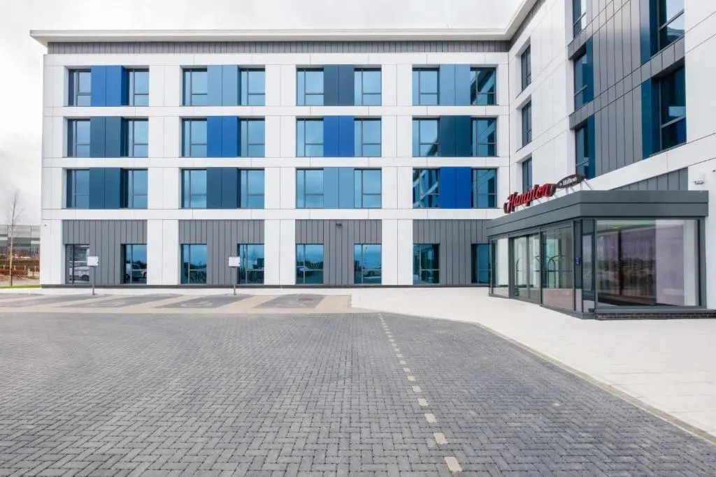 a large office building with a glass entrance at Hampton By Hilton Aberdeen Airport in Dyce