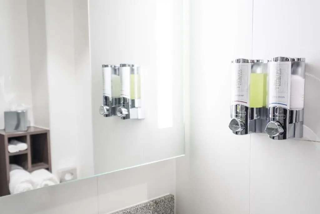 a bathroom with a mirror and some toiletries at Hampton By Hilton Aberdeen Airport in Dyce