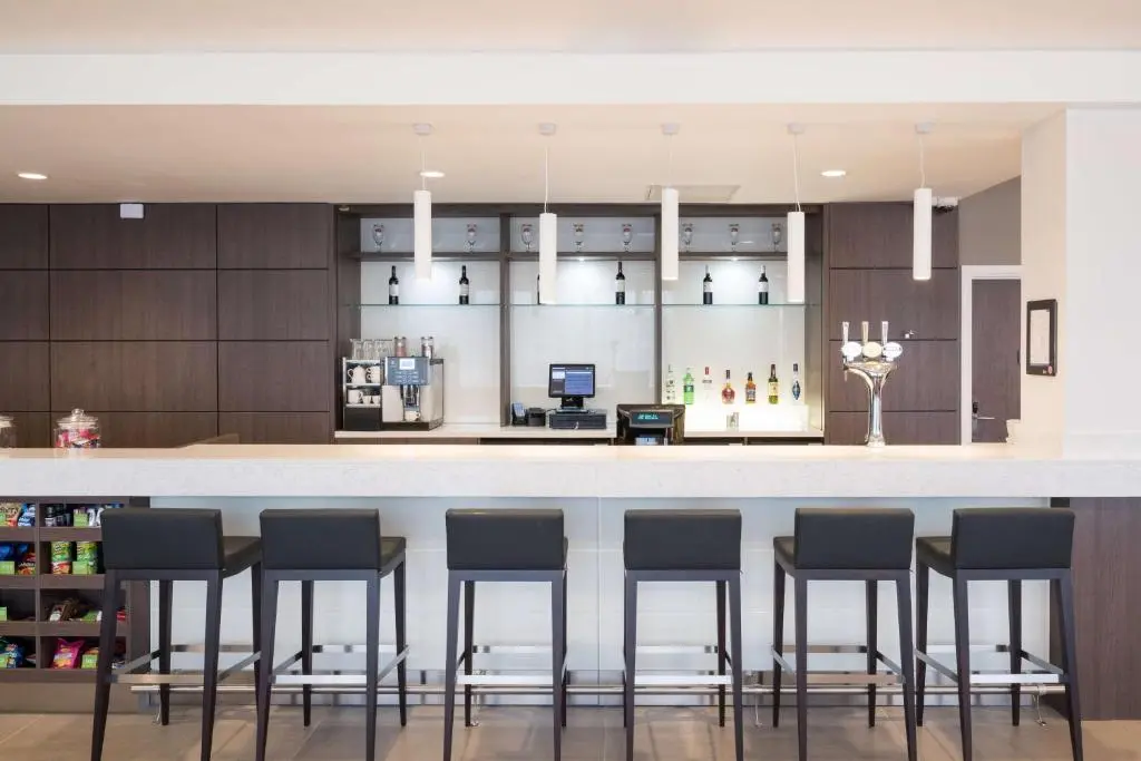 a kitchen with a bar with stools at Hampton By Hilton Aberdeen Airport in Dyce