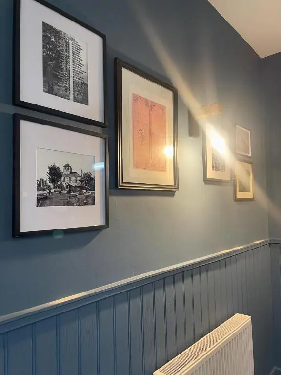 a room with pictures on the wall with a radiator at The Square Kintore in Kintore