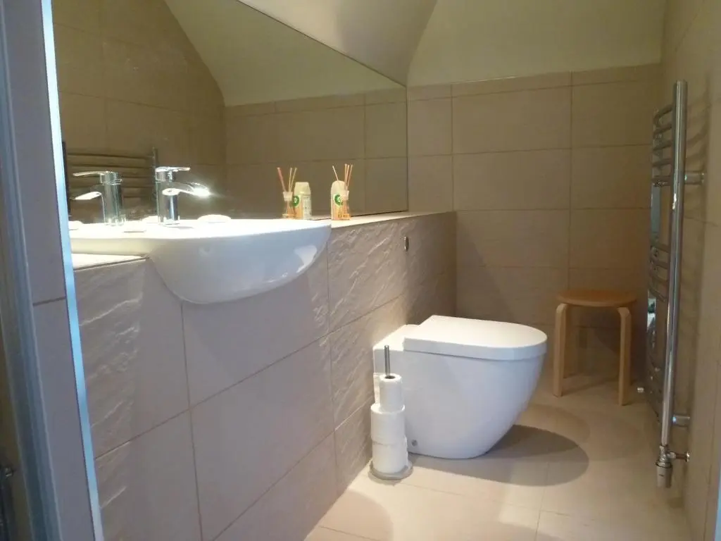 a bathroom with a sink and a toilet at Camusmore House in Aviemore