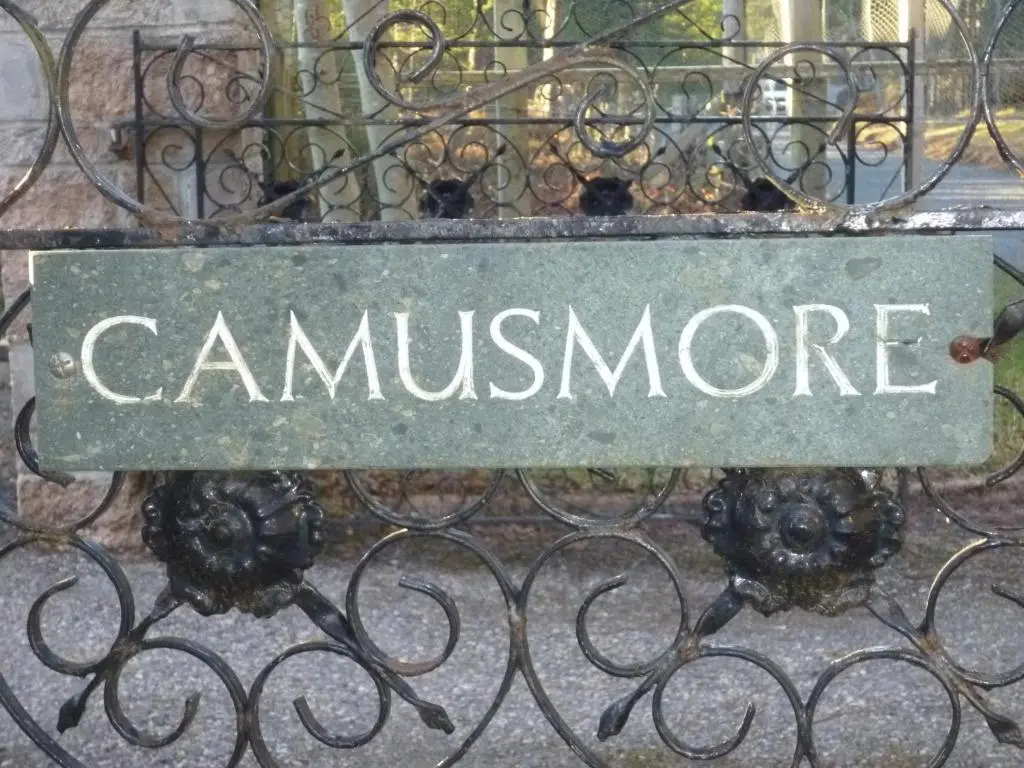 a sign on a iron fence with the wordamnesia at Camusmore House in Aviemore