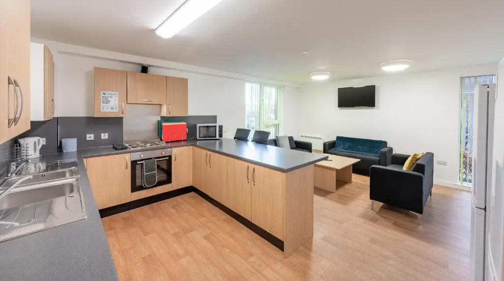 a kitchen with a counter and a living room at UHI Inverness - Campus Accommodation in Inverness