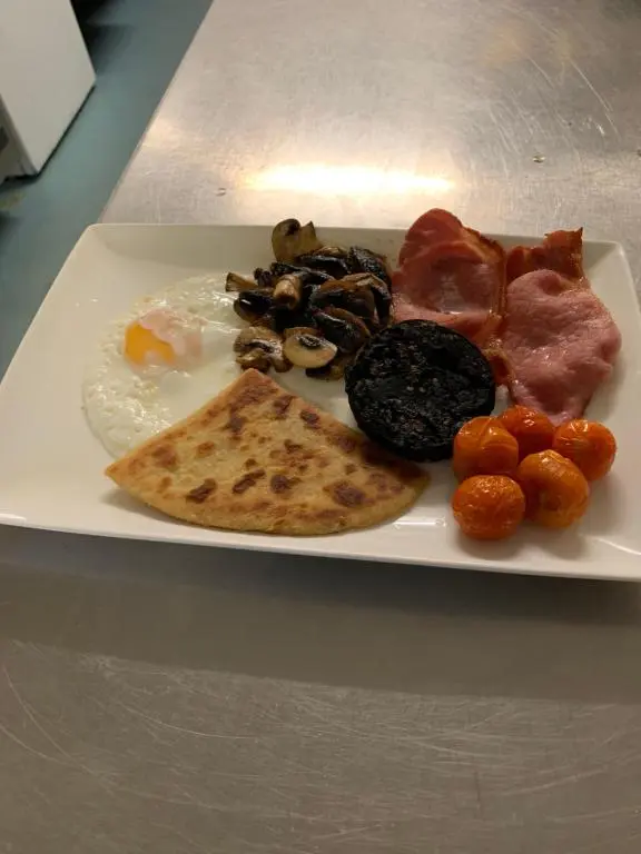a plate of breakfast food on a table at The Auld Kirk in Ballater