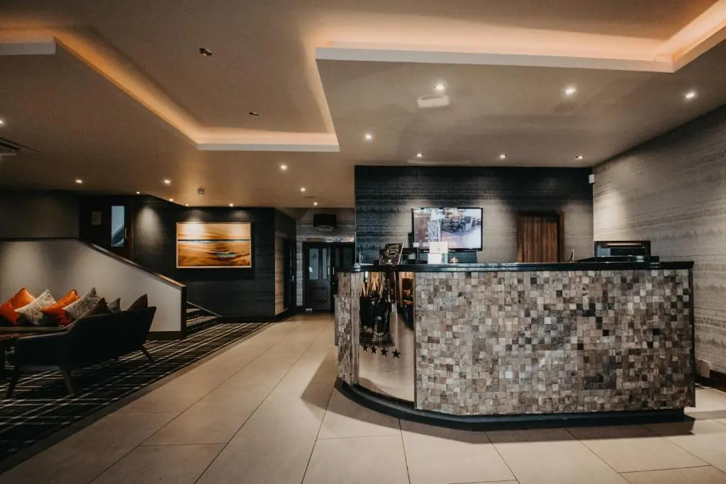 a lobby with a bar in the middle of a building at Banff Springs Hotel in Banff