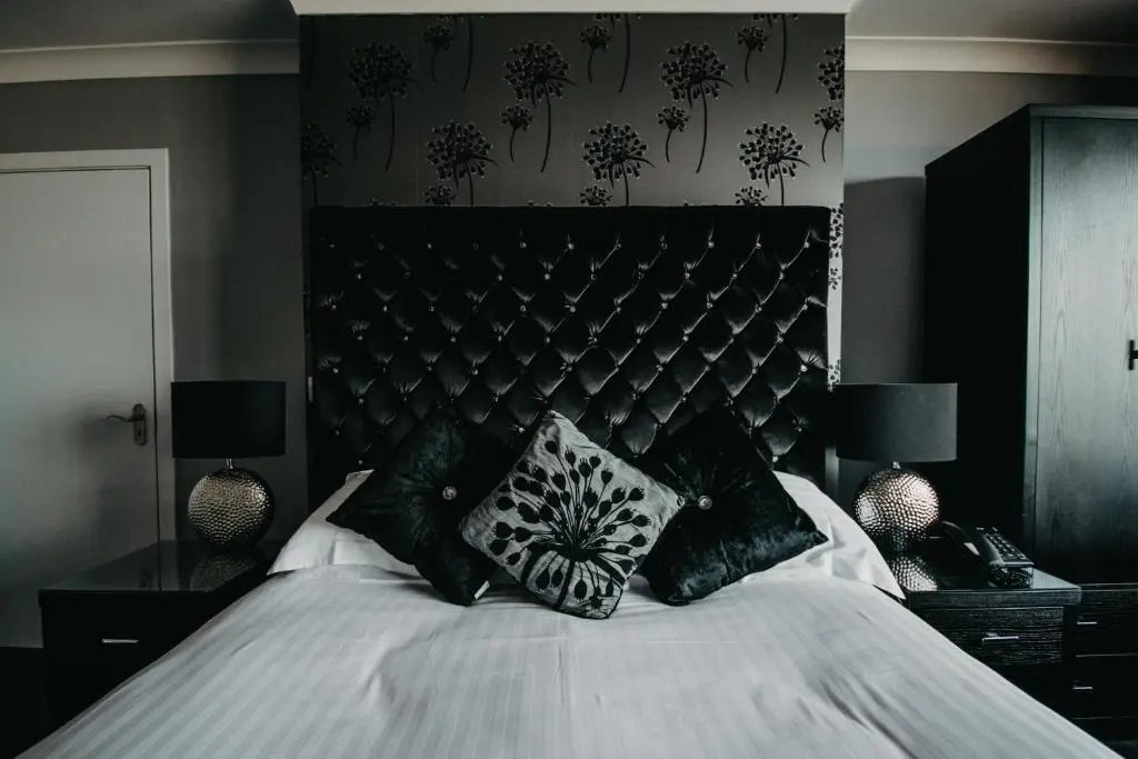 a black and white bedroom with a bed with pillows at Banff Springs Hotel in Banff