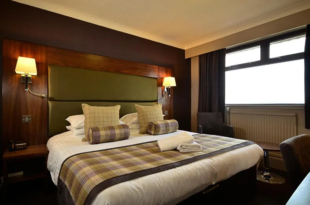 a hotel room with a large bed and a window at Banff Springs Hotel in Banff