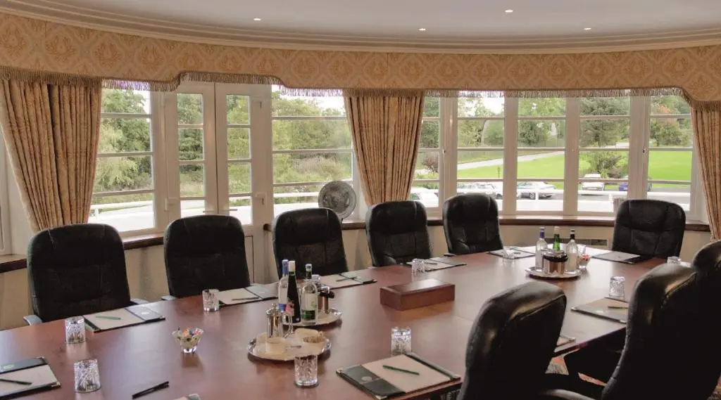a conference room with a large table and chairs at Macdonald Drumossie Hotel Inverness in Inverness
