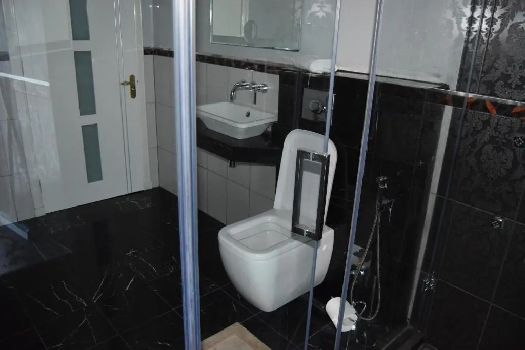a bathroom with a toilet and a sink at Amazing 4 Bed Scottish Baronial Style House in Westhill