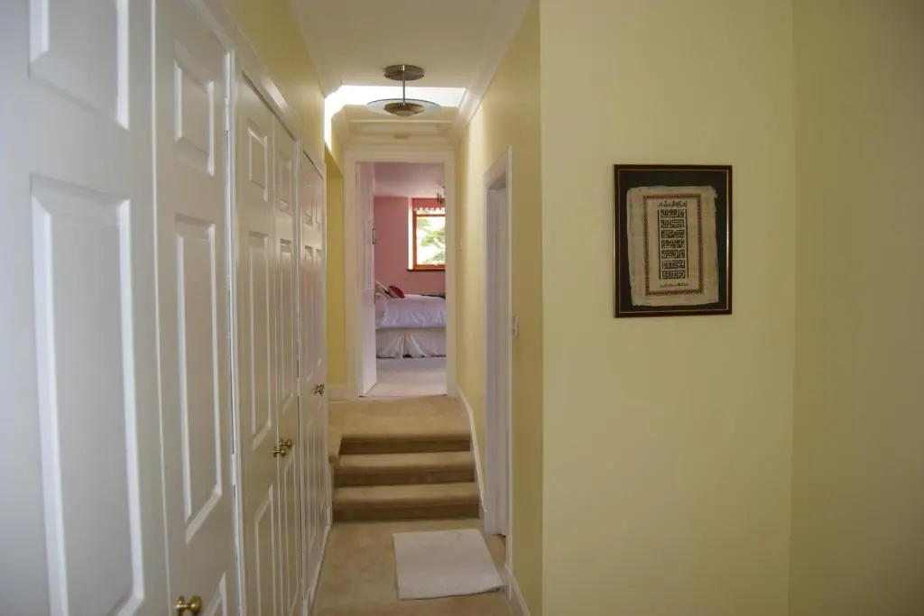 a hallway with stairs leading to a bedroom at Amazing 4 Bed Scottish Baronial Style House in Westhill