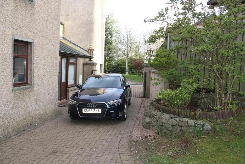 a black car parked in front of a house at Amazing 4 Bed Scottish Baronial Style House in Westhill