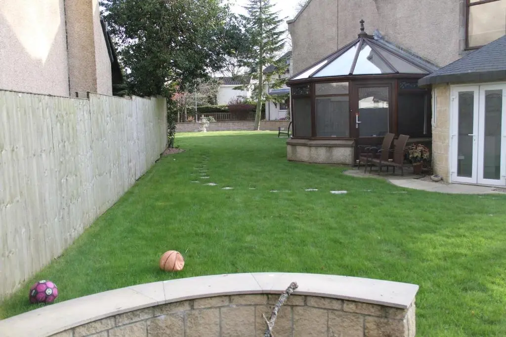 a backyard with a fence and a yard with a fence at Amazing 4 Bed Scottish Baronial Style House in Westhill
