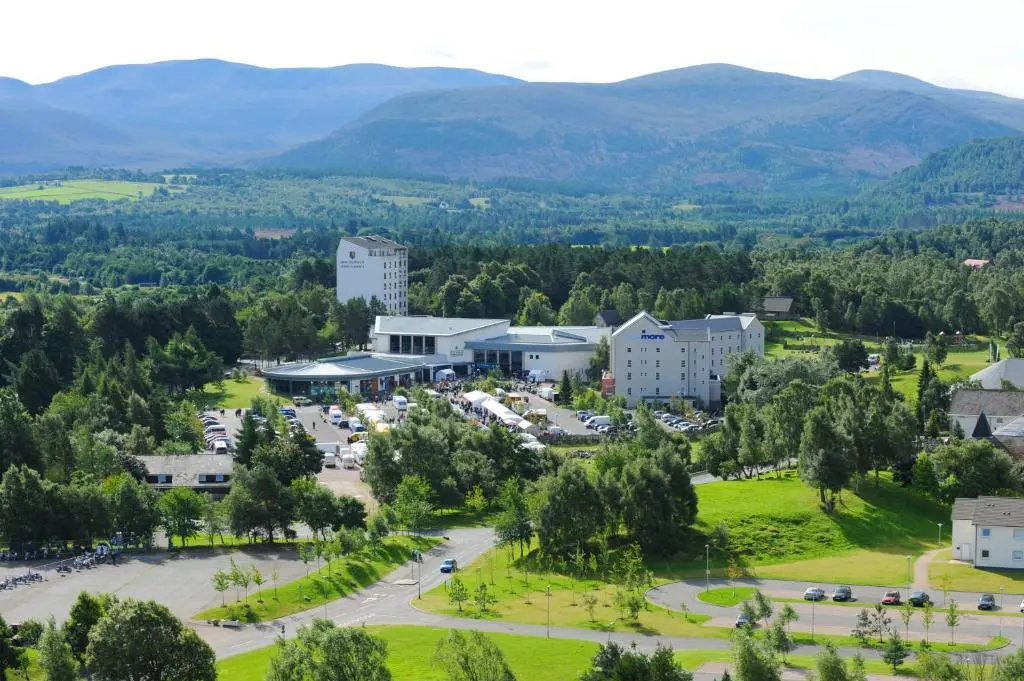 an aerial view of a town with mountains in the background at Macdonald Highlands Hotel at Macdonald Aviemore Resort in Aviemore
