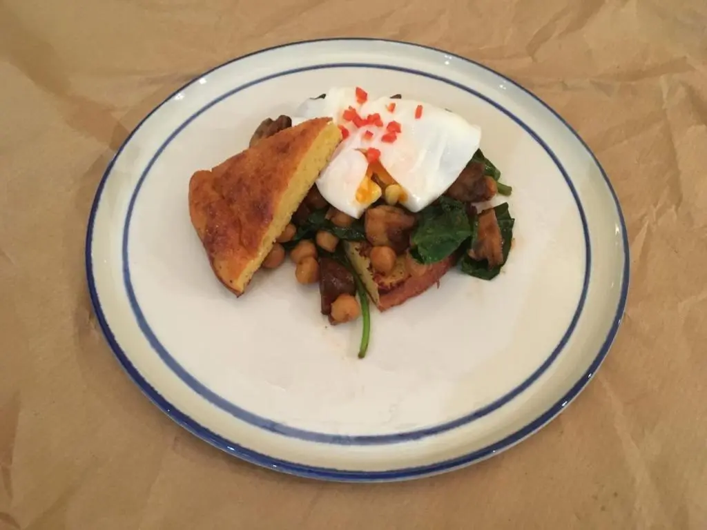 a plate of food with a sandwich and beans at Washington House in Nairn