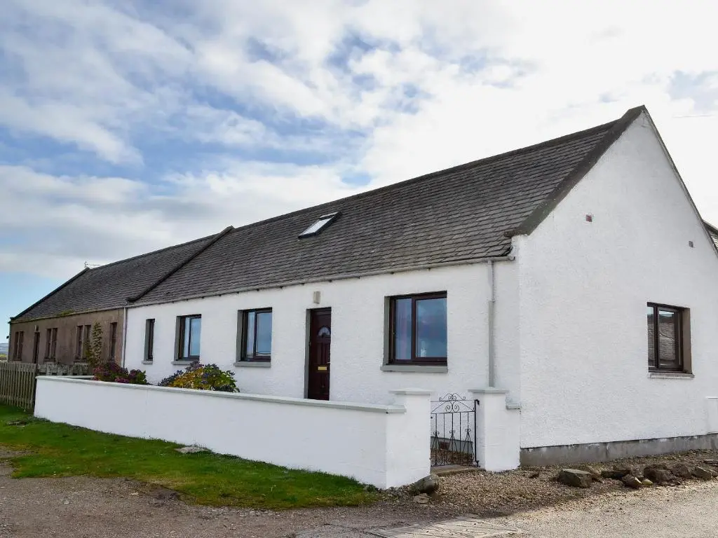 a white house with a black roof at Firth View in Garmouth