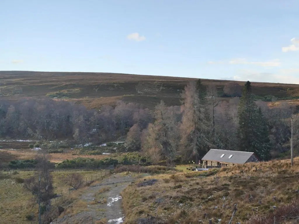 a small house on the side of a hill at Turin Nurin Cottage in Tomatin