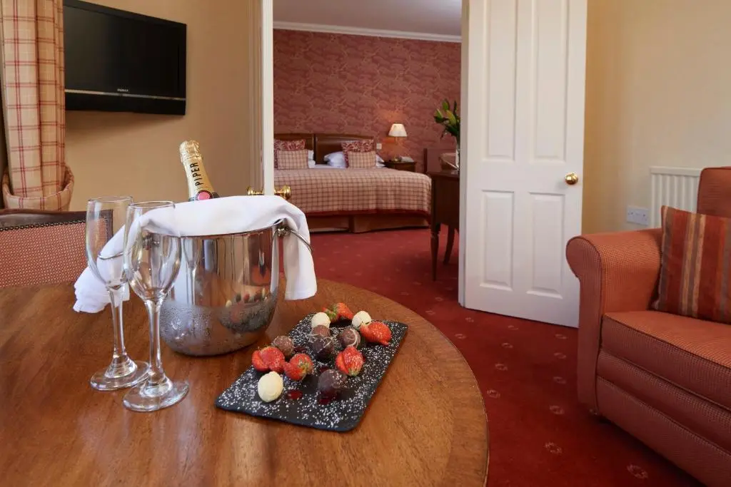 a table with a plate of fruit and a blender at Loch Ness Country House Hotel in Inverness
