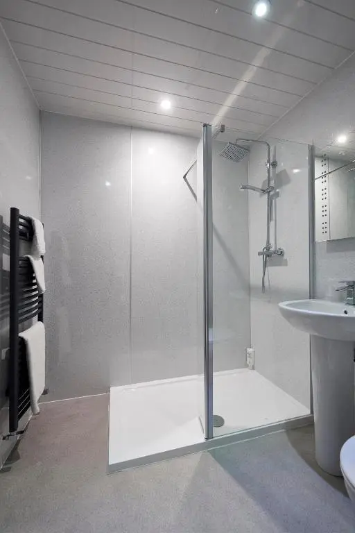 a bathroom with a shower and a sink at The Priory Hotel in Beauly