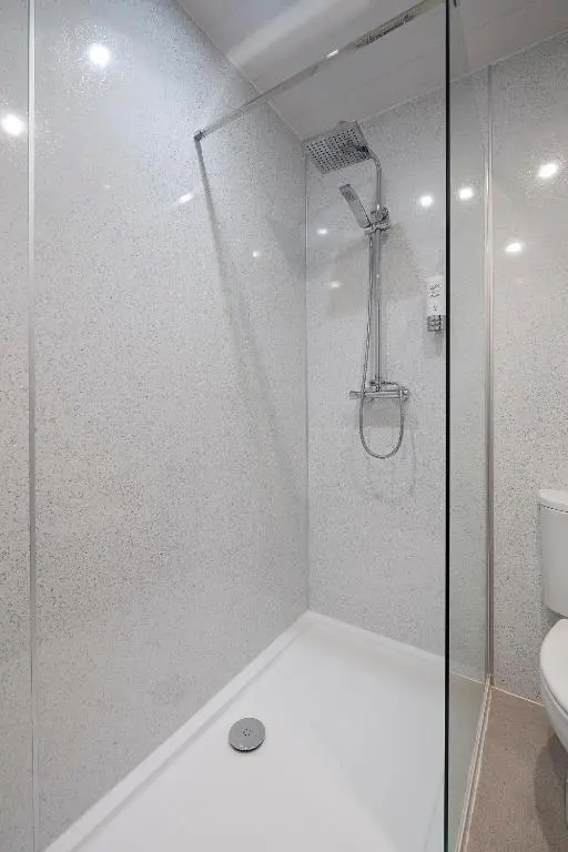 a shower with a glass door in a bathroom at The Priory Hotel in Beauly