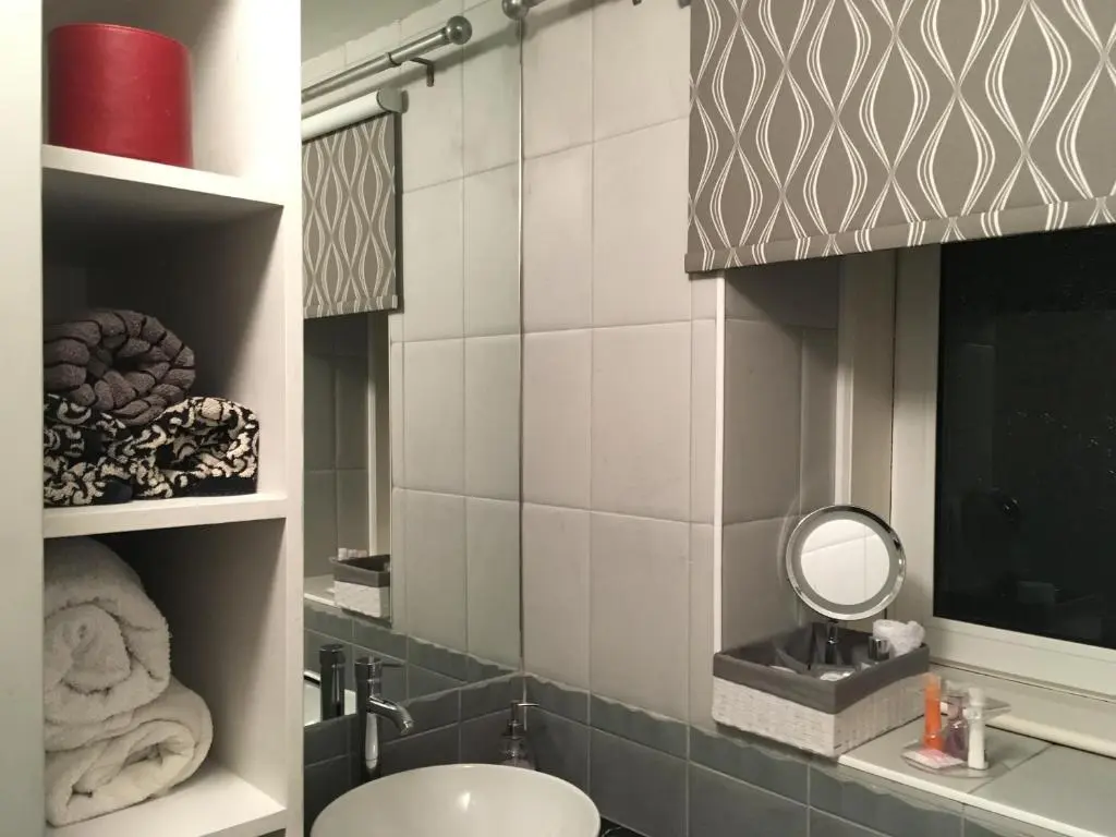a bathroom with a sink and a mirror at Urrard B&B in Dingwall