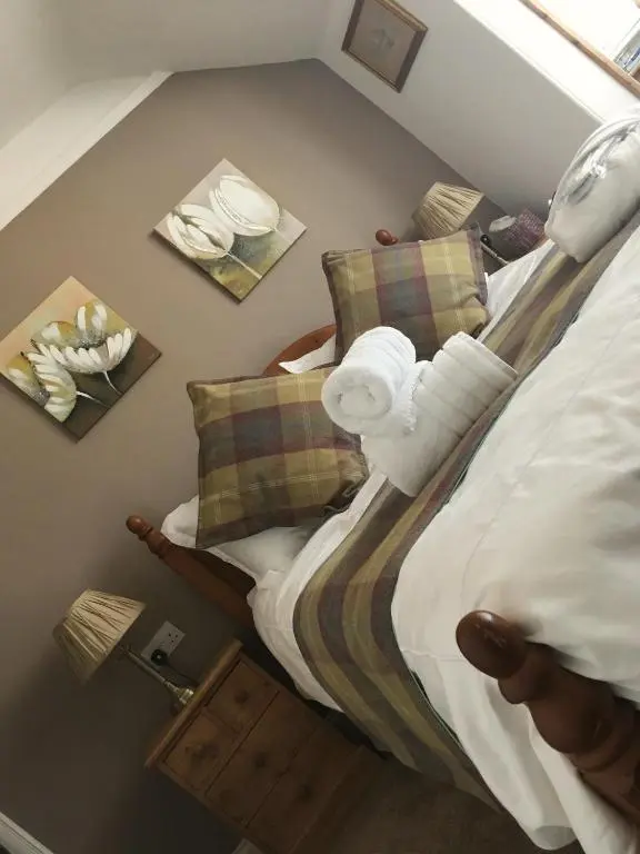 a bedroom with a bed with pillows on it at Urrard B&B in Dingwall