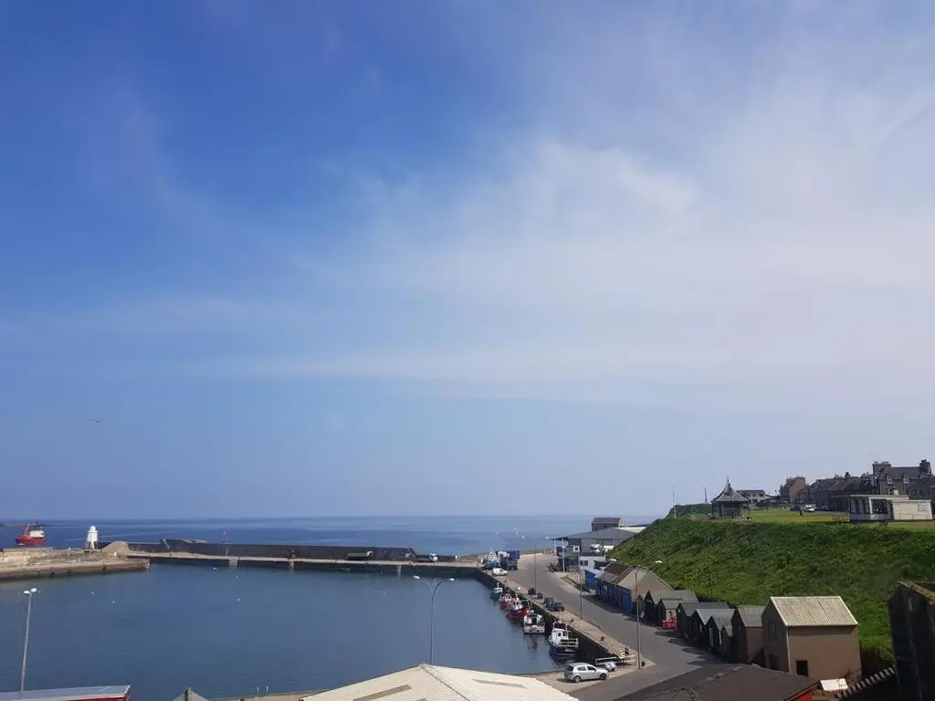 a view of a harbor with boats in the water at House by the Harbour - NC500 Route in Wick