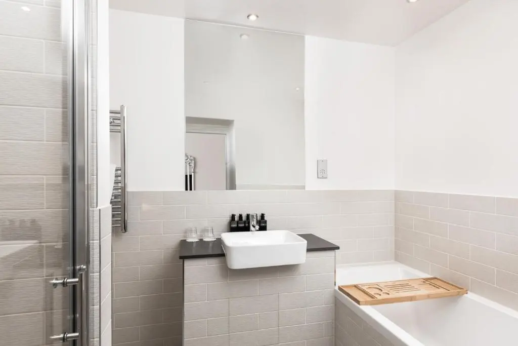 a bathroom with a sink and a tub and a shower at Tulloch Castle Hotel \u2018A Bespoke Hotel\u2019 in Dingwall