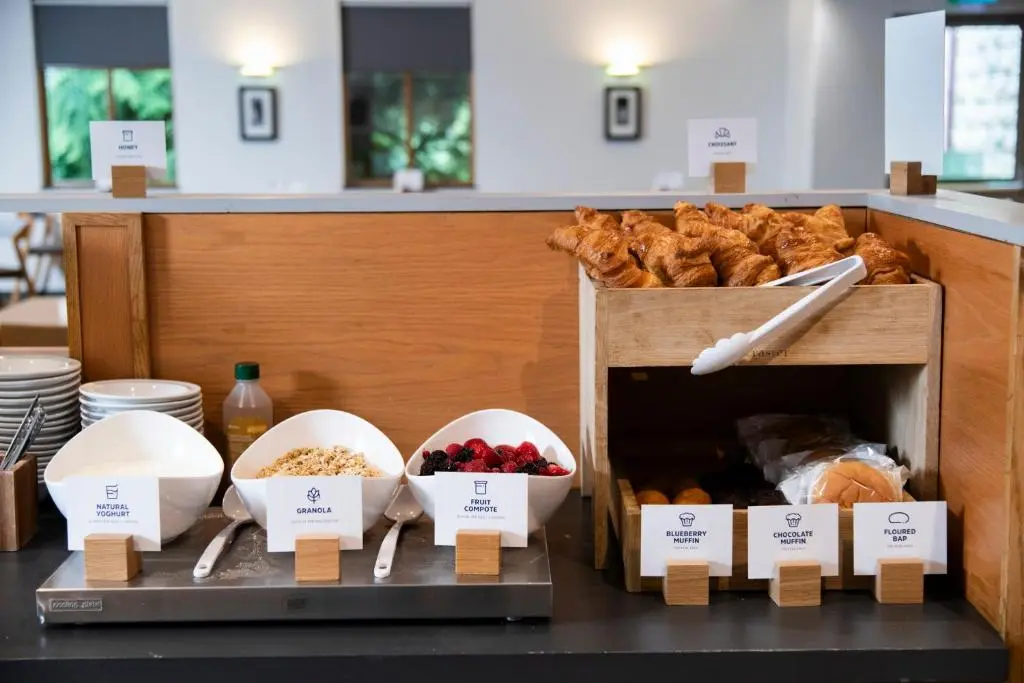 a bakery with bread and bowls of food on a counter at Holiday Inn Express Inverness by IHG in Inverness