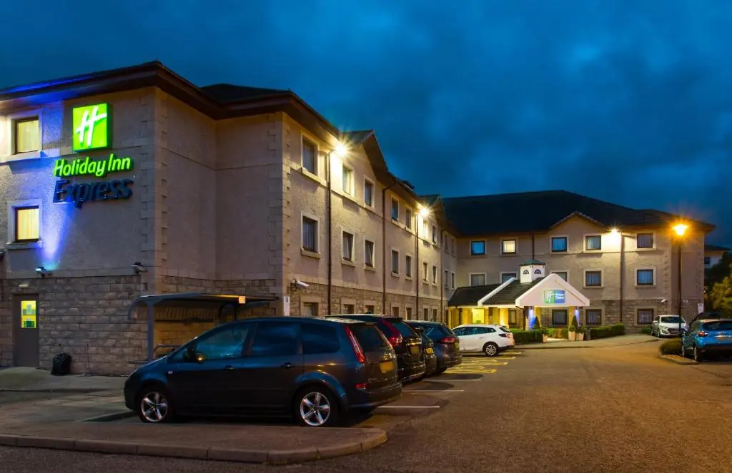 a parking lot in front of a hotel at night at Holiday Inn Express Inverness by IHG in Inverness