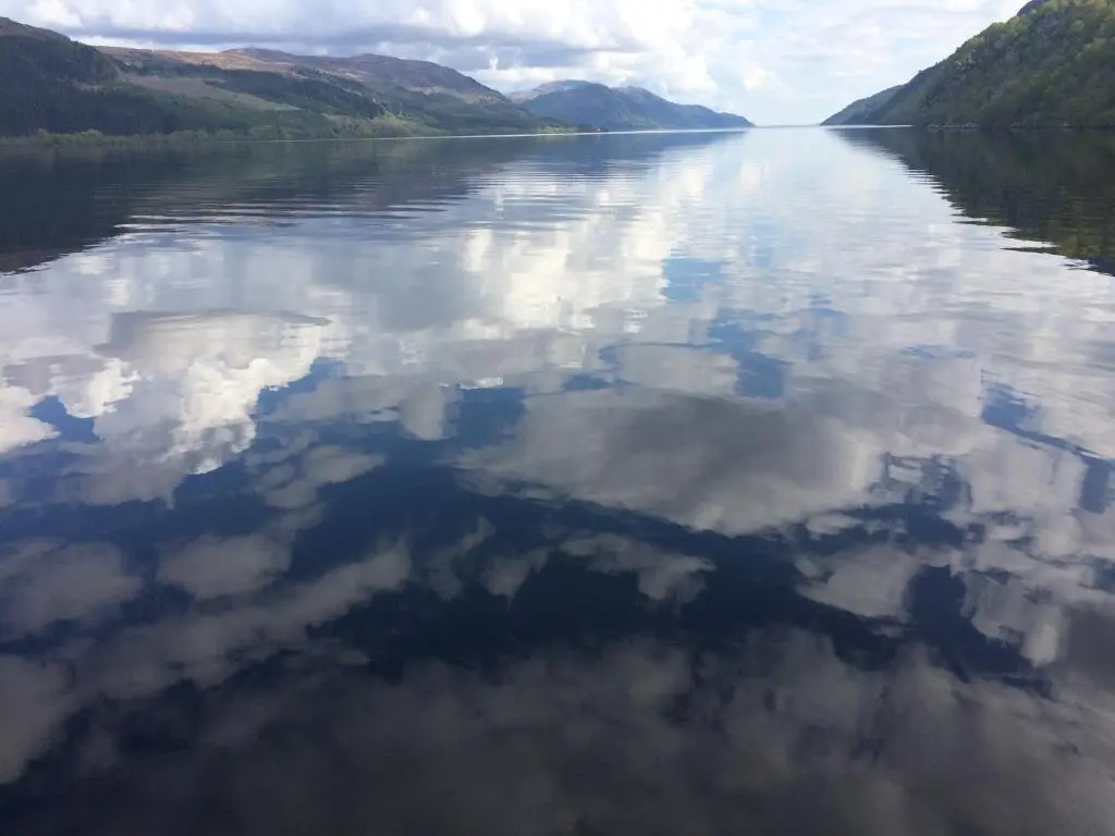 a view of a lake with clouds in the water at The Wee Lodge in Inverness