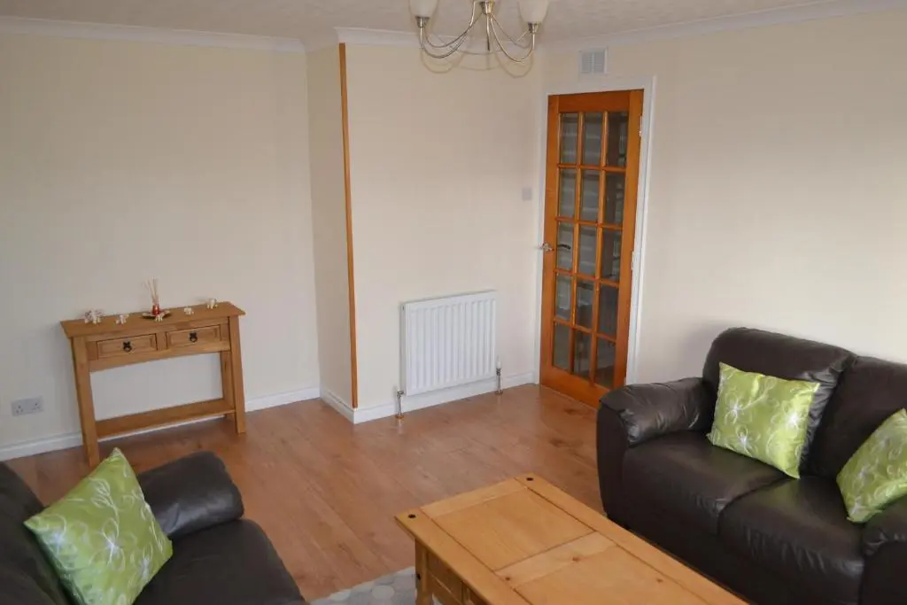 a living room with a couch and a table at Wick Apartment in Wick