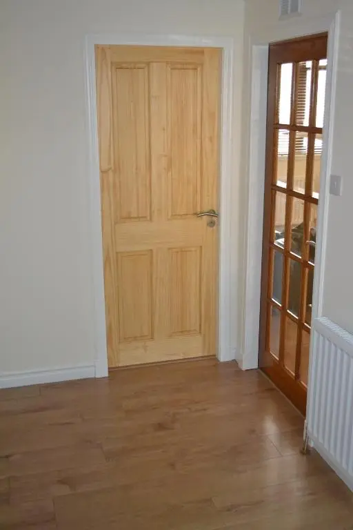 a room with a wooden door and a wooden floor at Wick Apartment in Wick