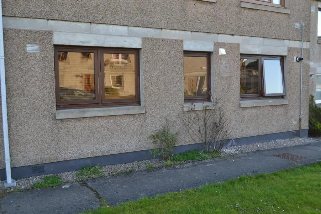 a building with three windows on the side of it at Wick Apartment in Wick