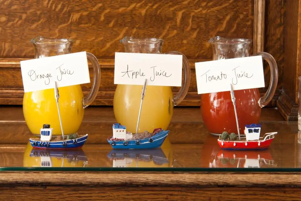 a group of three glasses of juice on a shelf at Sunny Brae Bed & Breakfast in Nairn
