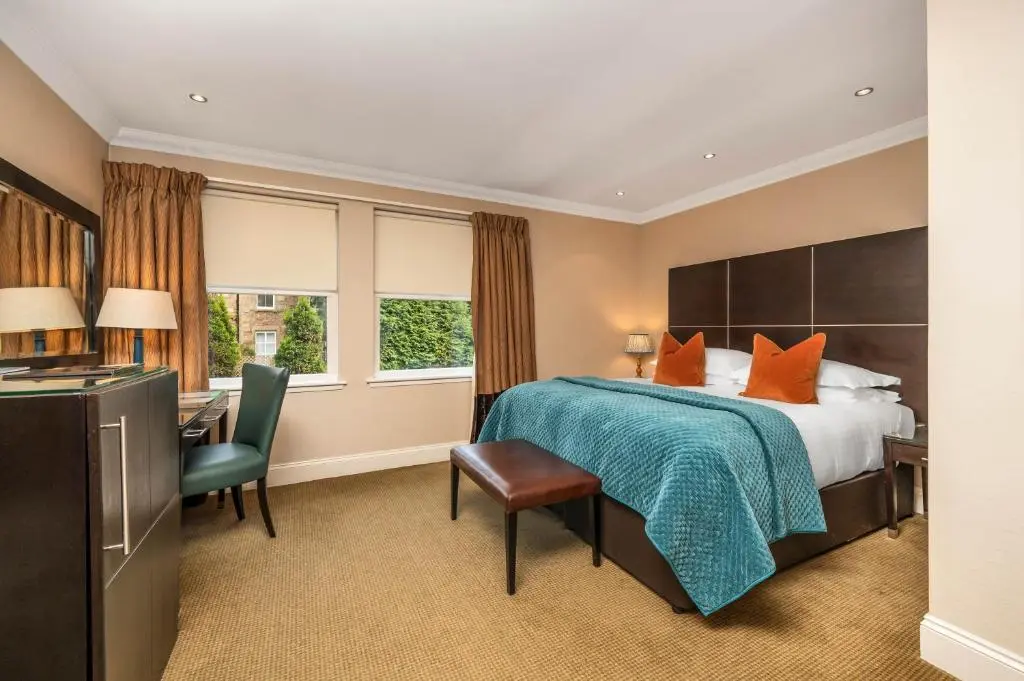 a hotel room with a bed and a desk at Rocpool Reserve in Inverness