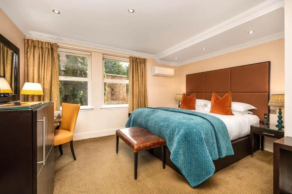 a hotel room with a bed and a desk at Rocpool Reserve in Inverness