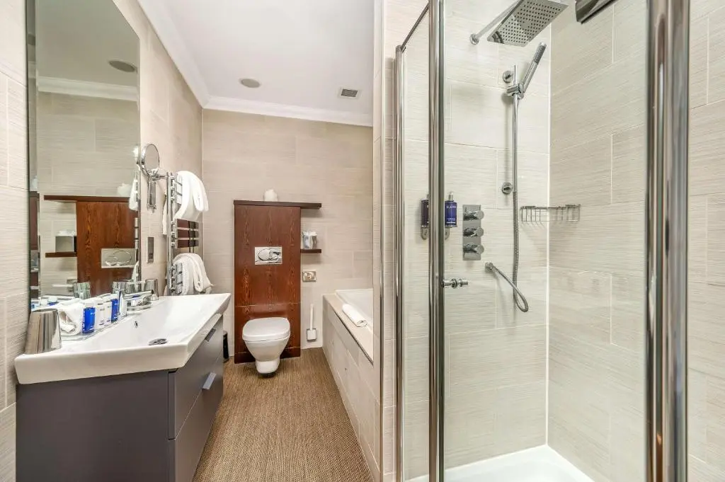 a bathroom with a shower and a sink and a toilet at Rocpool Reserve in Inverness
