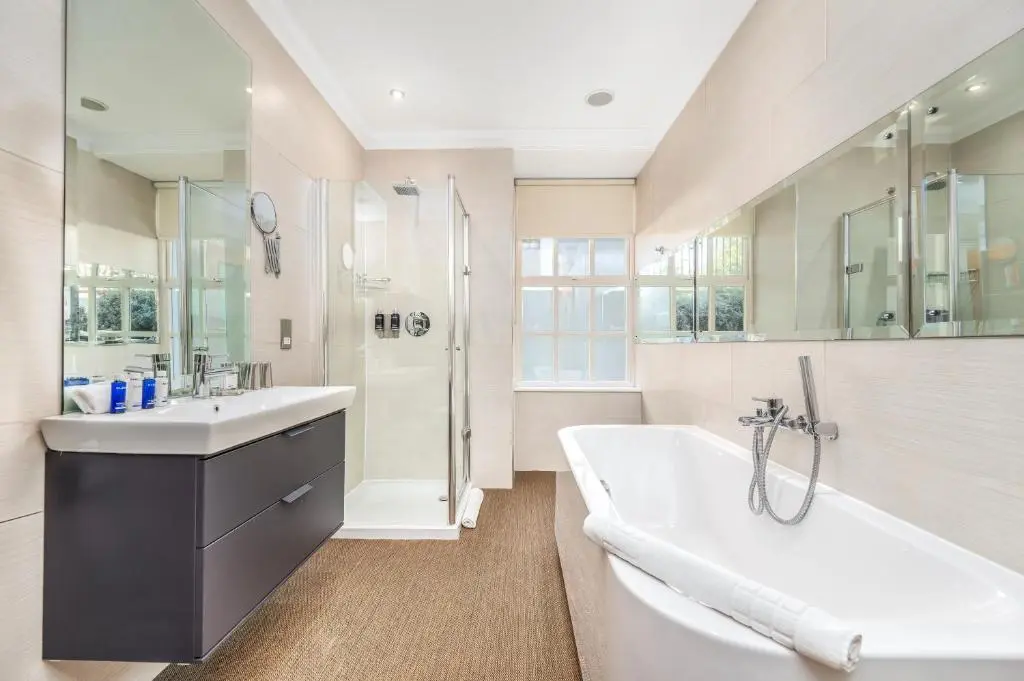 a bathroom with a tub and a sink and a shower at Rocpool Reserve in Inverness