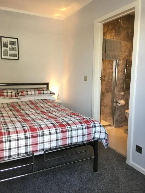 a bedroom with a bed and a shower at 32a railside in Inverness