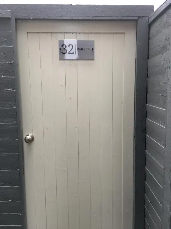a garage door with a sign on it at 32a railside in Inverness