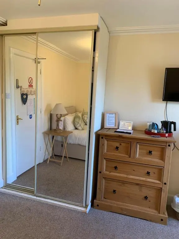a room with a glass door leading to a bedroom at The Ship Inn in Invergordon