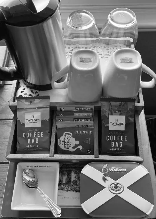 a table with a coffee bag and a box of coffeeaband at Dalgreine Guest House in Blair Atholl