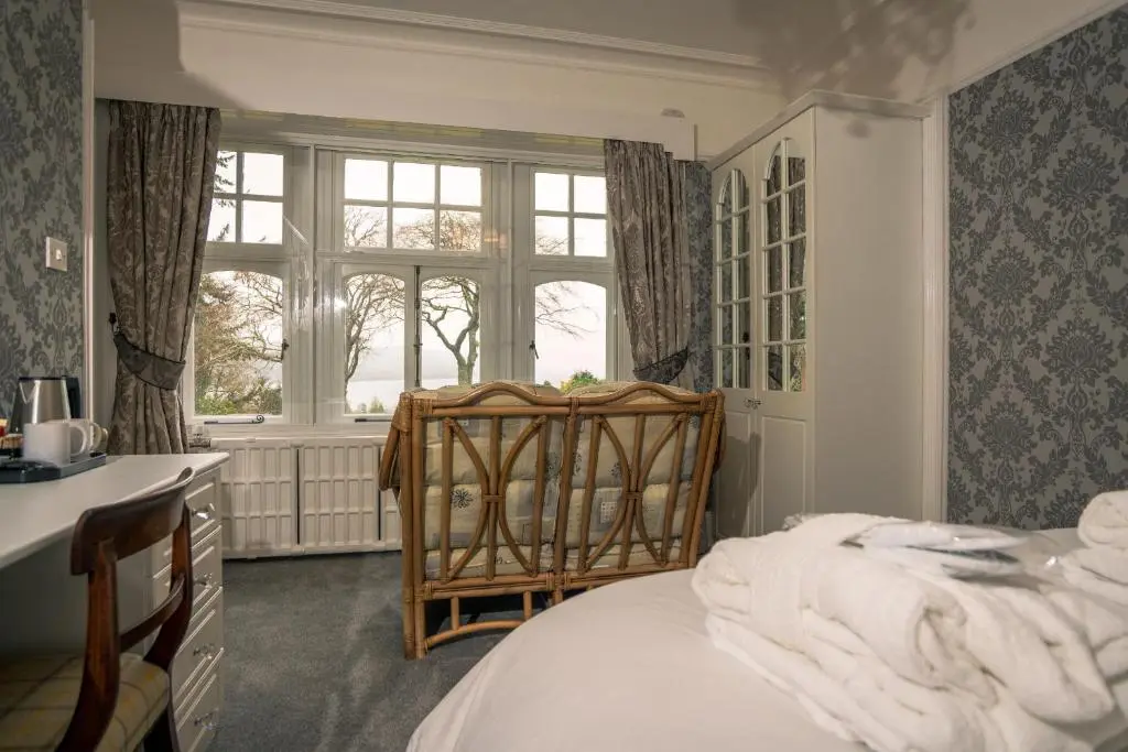 a bedroom with a bed and a window at Foyers Bay Country House in Foyers