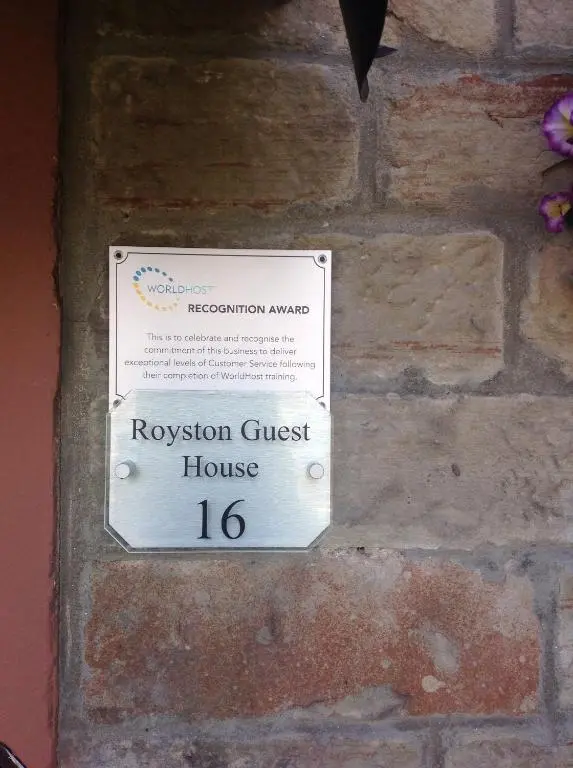 a museum guest house sign on a brick wall at Royston Guest House Inverness in Inverness