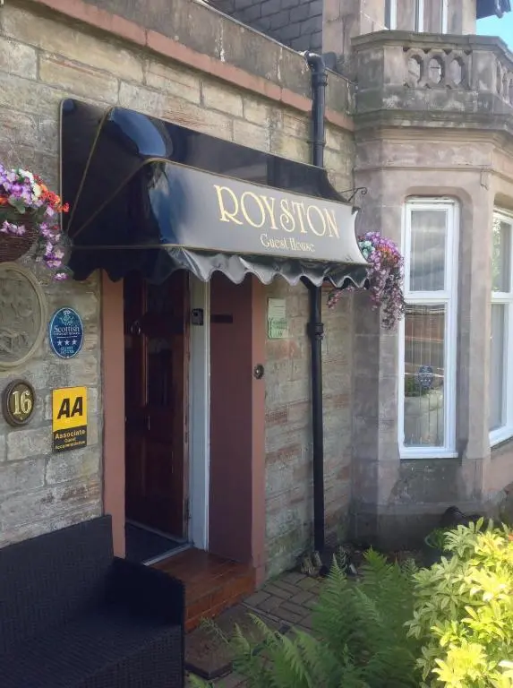 a sign for a restaurant on the front of a building at Royston Guest House Inverness in Inverness