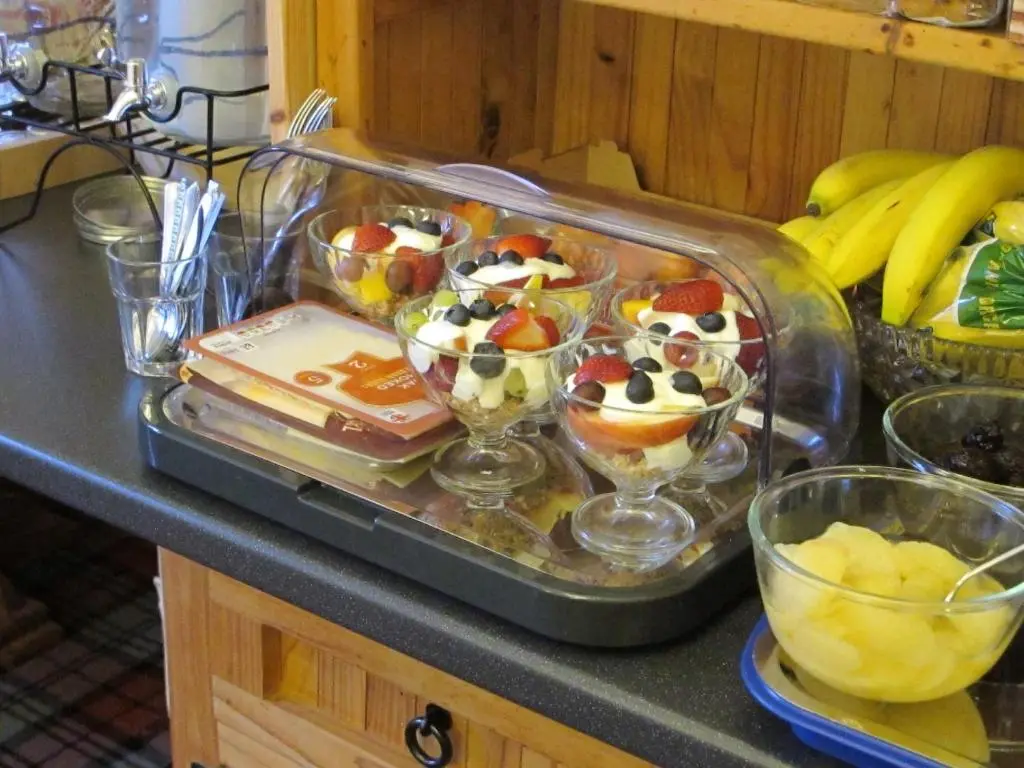 a tray of desserts in bowls on a counter at Royston Guest House Inverness in Inverness