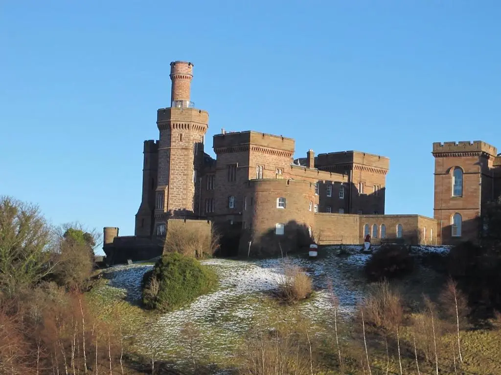 an old castle with two towers on a hill at Royston Guest House Inverness in Inverness