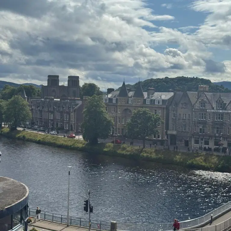 a view of a city with a river and buildings at Apartment 306 By the Bridge in Inverness